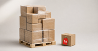 Shrink-wrapped return pallet next to a single inspected box with a red half-price tag — are Amazon return pallets worth it