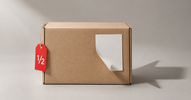 Delivery box with a peeling return label and red half-price tag — what are Amazon returns and are they worth buying in Canada