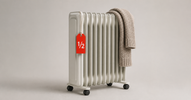 Oil-filled radiator heater with a knitted scarf and a red half-price tag — open-box space heater deals Canada