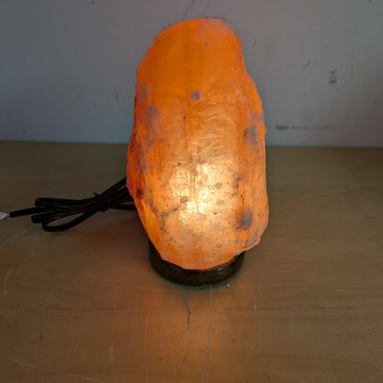 Actual unit: Himalayan salt lamp lit on its wooden base