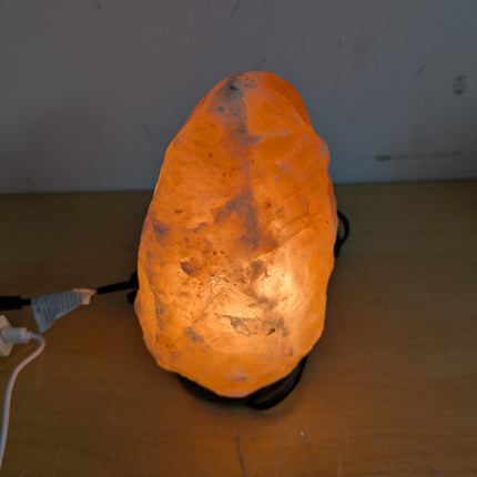 Actual unit: Himalayan salt lamp lit on its wooden base